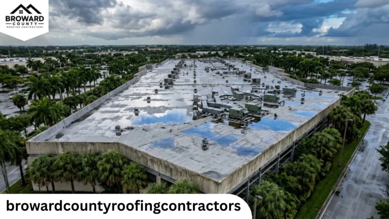 Aerial view of a flat commercial roof with ponding water from clogged drains in Broward County